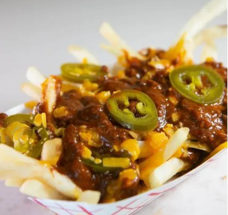 Chili Cheese Fries - Crispy fries loaded with homemade chili, melted cheese, and jalapeños